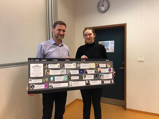 Steinn rektor tekur hér við mynd úr hendi Nönnu sem er stelpa sem diffrar